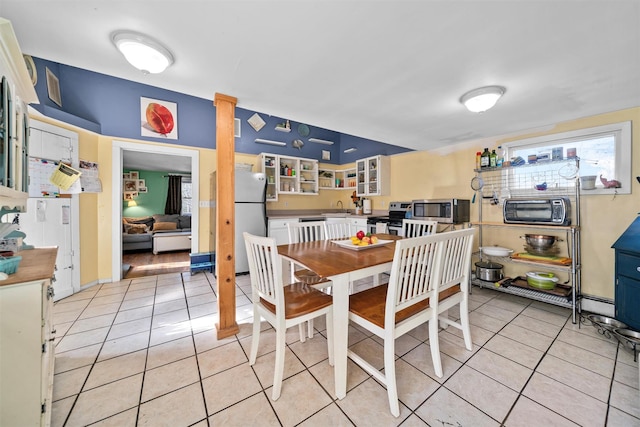 dining area with light tile patterned floors and sink