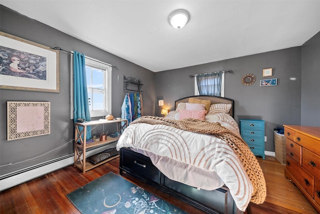 bedroom featuring dark hardwood / wood-style flooring and a baseboard heating unit