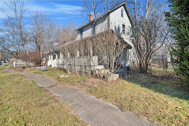 view of side of property with a lawn