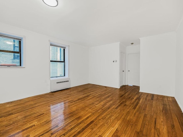 unfurnished room with hardwood / wood-style floors