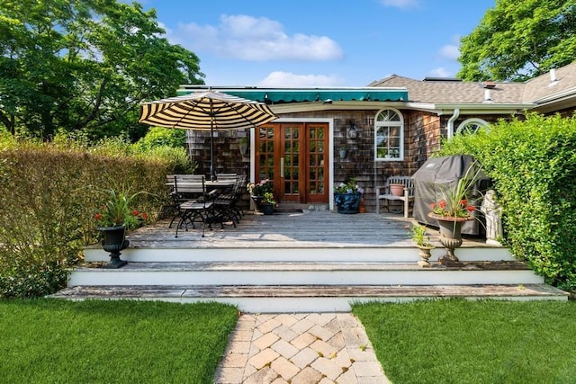 wooden deck featuring a grill