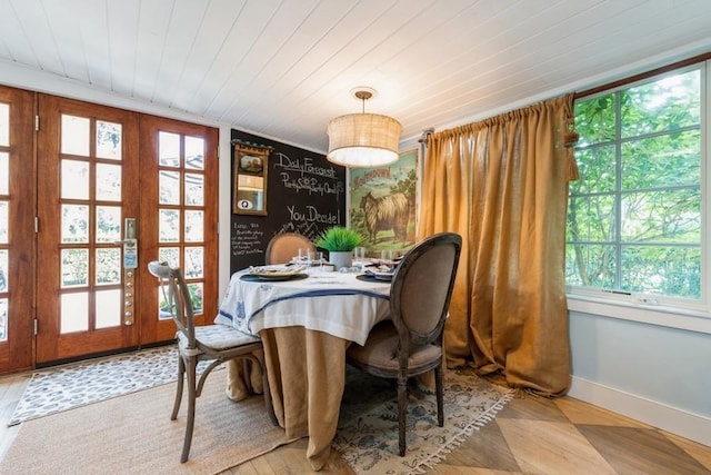 dining space with french doors and wooden ceiling