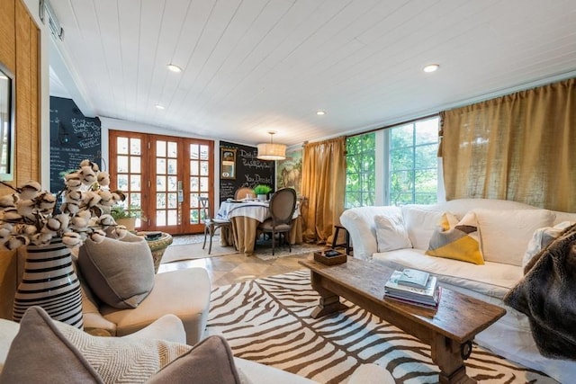 tiled living room featuring french doors, plenty of natural light, wood ceiling, and lofted ceiling