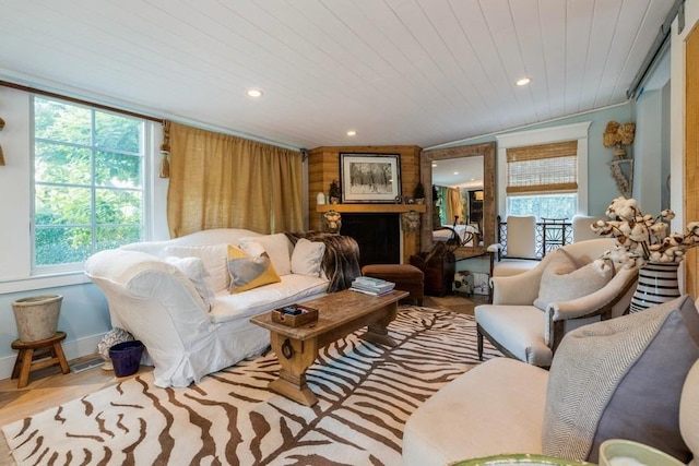 living room featuring vaulted ceiling, wooden ceiling, a wealth of natural light, and light hardwood / wood-style flooring