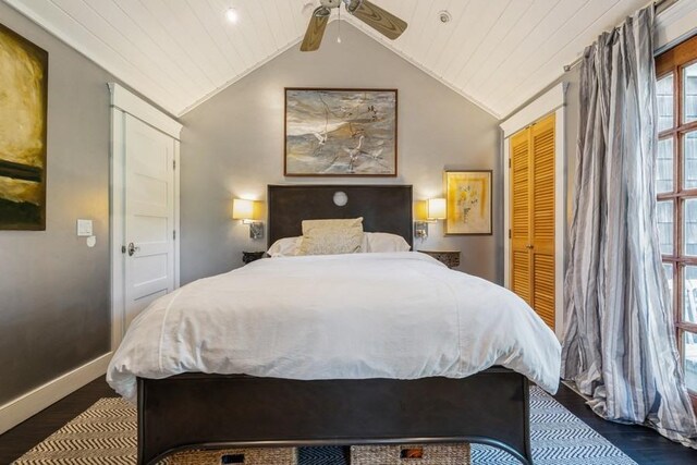 bedroom with vaulted ceiling, a closet, dark wood-type flooring, and ceiling fan