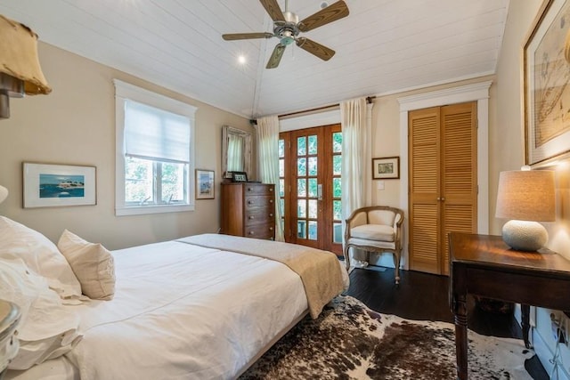 bedroom with hardwood / wood-style flooring, ceiling fan, a closet, and multiple windows