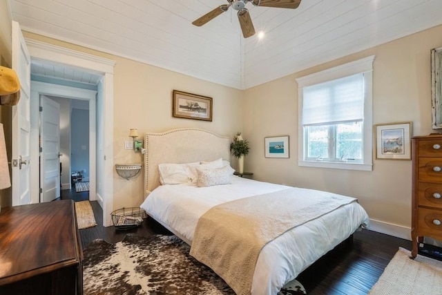 bedroom with dark hardwood / wood-style flooring and ceiling fan