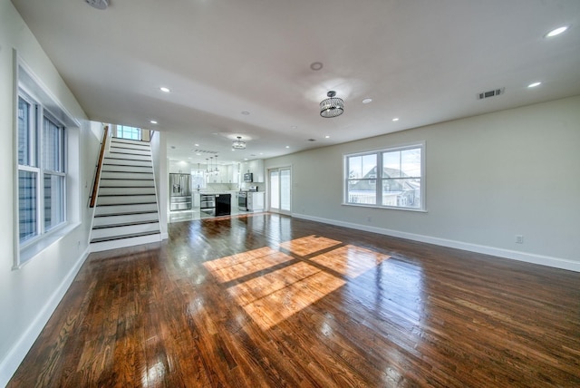 unfurnished living room with dark hardwood / wood-style floors