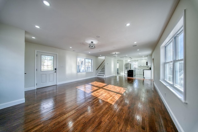 unfurnished living room with dark hardwood / wood-style floors