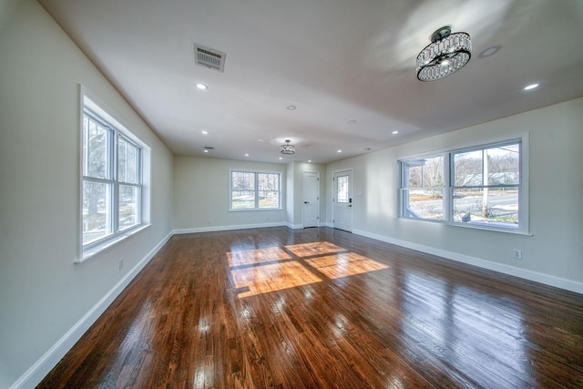 unfurnished living room with dark hardwood / wood-style flooring