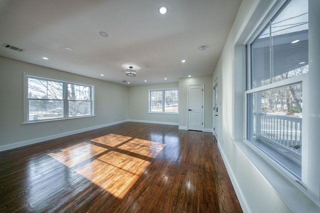 unfurnished room with dark hardwood / wood-style floors and a wealth of natural light