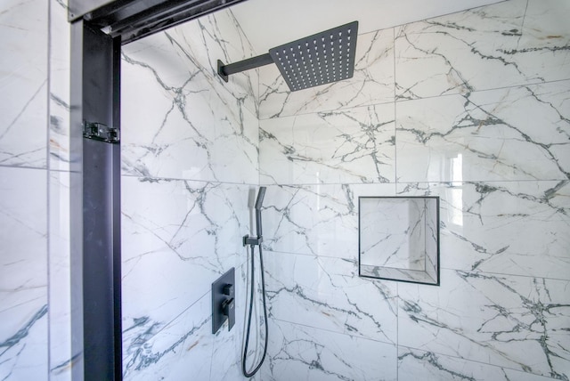 interior details featuring tiled shower