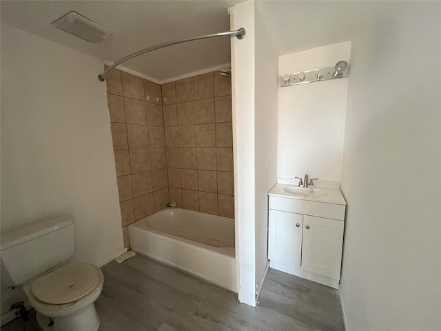 full bathroom featuring toilet, vanity, tiled shower / bath combo, and hardwood / wood-style flooring