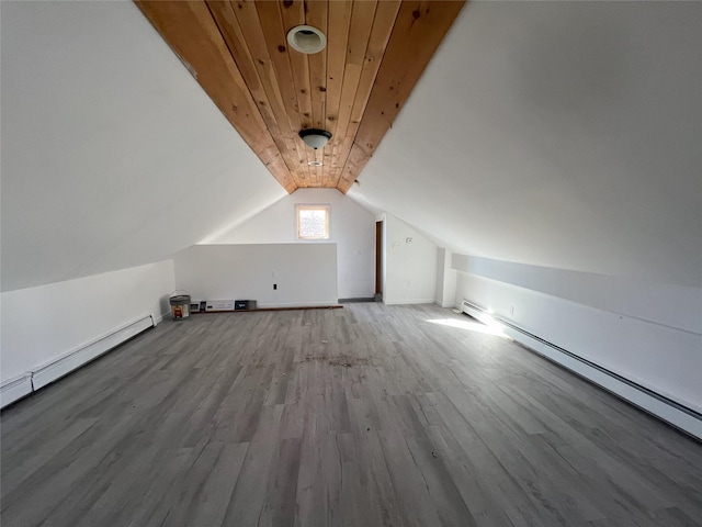 bonus room featuring wood ceiling, wood-type flooring, vaulted ceiling, and a baseboard heating unit