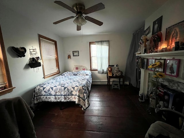 bedroom with ceiling fan, a baseboard radiator, and dark hardwood / wood-style floors