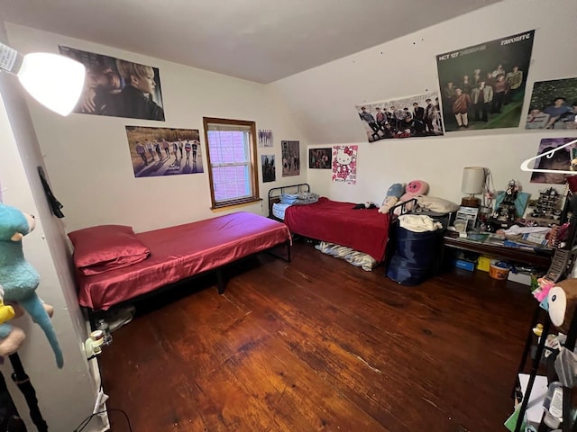 bedroom with hardwood / wood-style floors and vaulted ceiling