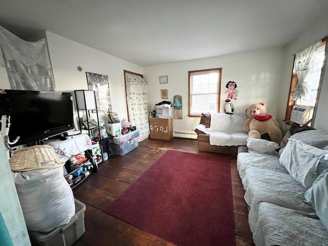 living room featuring cooling unit, dark hardwood / wood-style flooring, and a baseboard heating unit