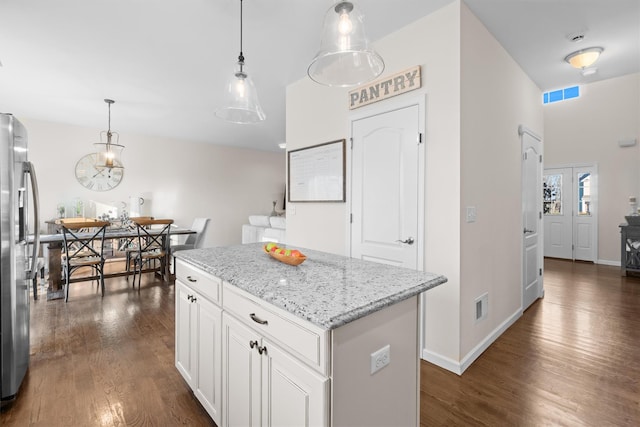 kitchen with white cabinetry, a center island, hanging light fixtures, and dark hardwood / wood-style floors