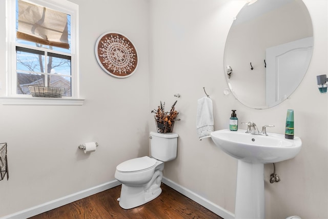 bathroom featuring sink, hardwood / wood-style floors, and toilet