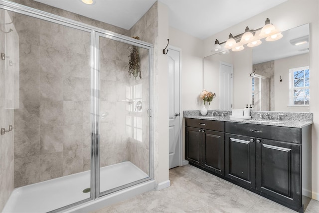 bathroom featuring vanity and a shower with door