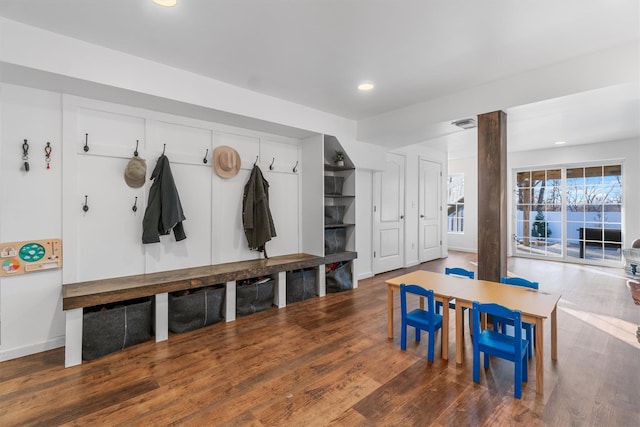 mudroom with dark hardwood / wood-style floors and ornate columns