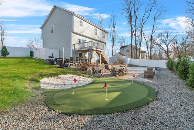 rear view of property with a yard and a patio area