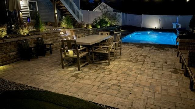 pool at night with a patio