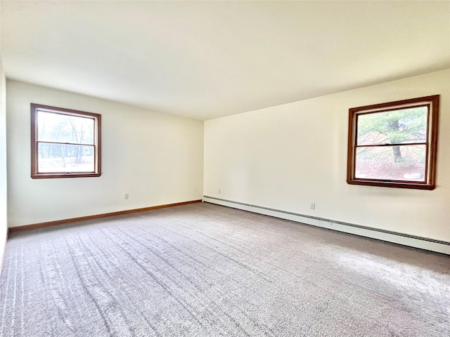 carpeted spare room with a baseboard radiator