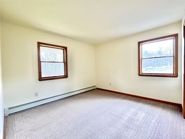 unfurnished room with carpet flooring, plenty of natural light, and a baseboard radiator