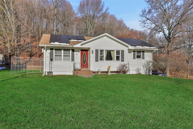 ranch-style house with a front lawn and solar panels