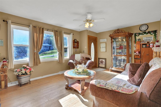 living room featuring light wood-type flooring and ceiling fan