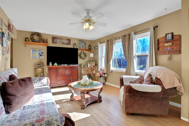 living room with ceiling fan and light hardwood / wood-style floors