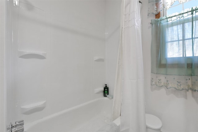 bathroom featuring shower / bath combination with curtain and toilet