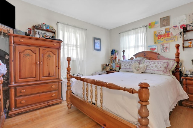 bedroom featuring light wood-type flooring and multiple windows