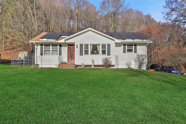 single story home featuring a front lawn and solar panels