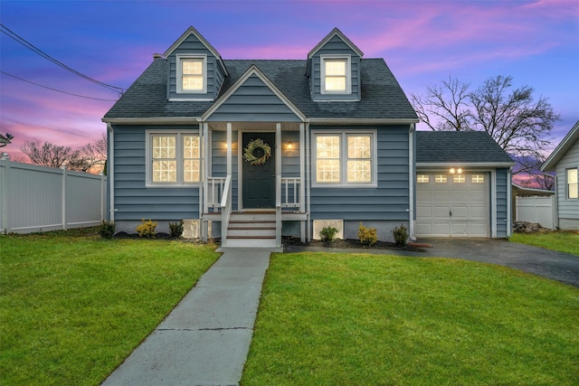 view of front of house with roof with shingles, driveway, fence, and a front lawn