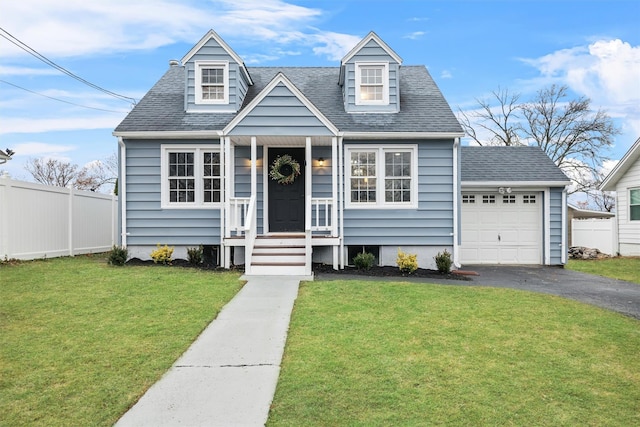 view of front of property with a front yard, an attached garage, aphalt driveway, fence, and roof with shingles