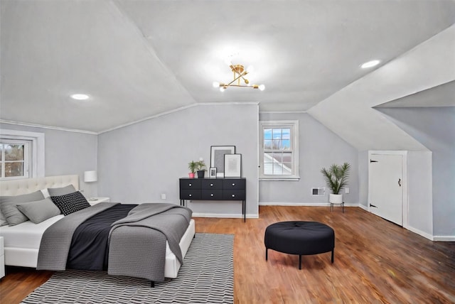bedroom featuring baseboards, vaulted ceiling, and wood finished floors
