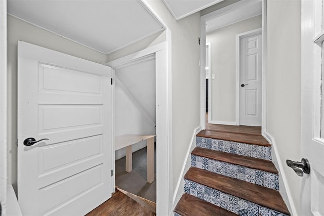 stairs with baseboards and wood finished floors