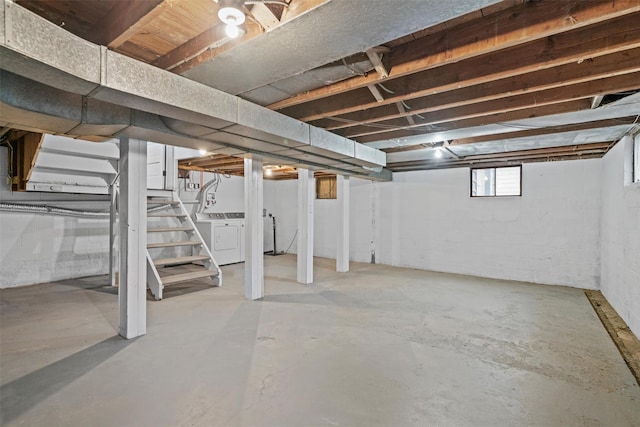 below grade area featuring stairs and washing machine and dryer