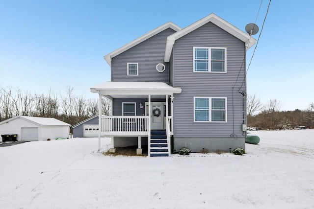 front of property with an outbuilding, a porch, and a garage