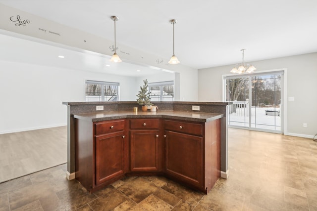 kitchen with decorative light fixtures, a center island, and a chandelier