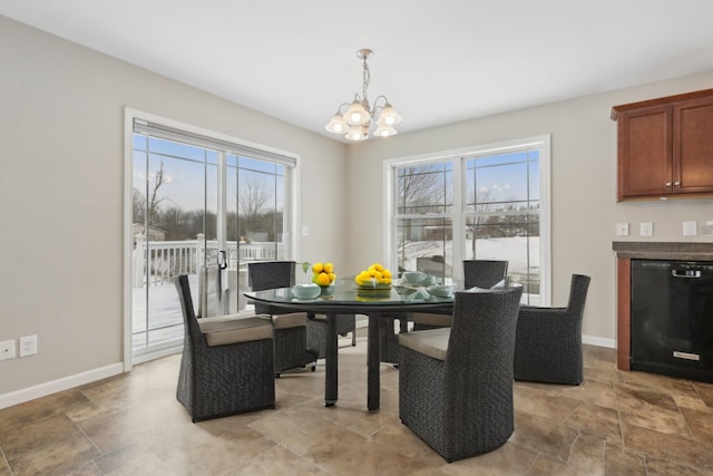 dining space featuring a wealth of natural light and a chandelier