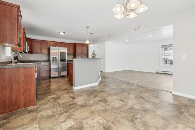 kitchen featuring a kitchen island, a baseboard radiator, appliances with stainless steel finishes, and pendant lighting