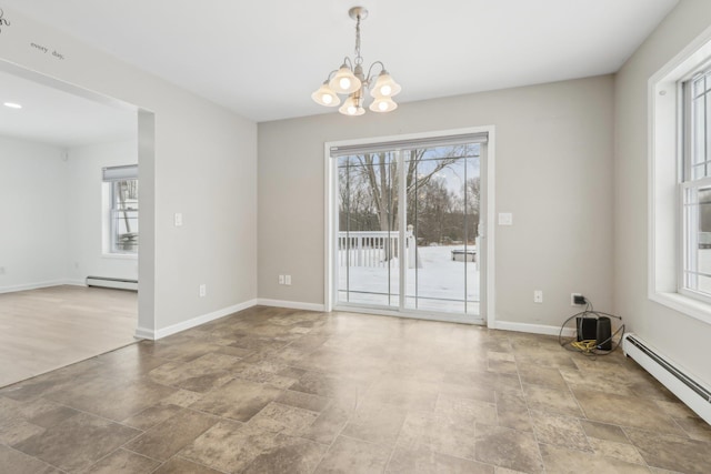 empty room with a notable chandelier and a baseboard radiator