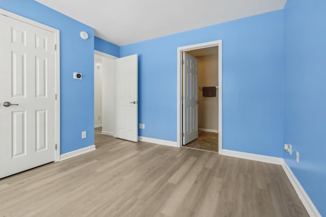 unfurnished bedroom with light wood-type flooring