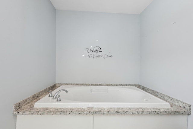 bathroom with a relaxing tiled tub