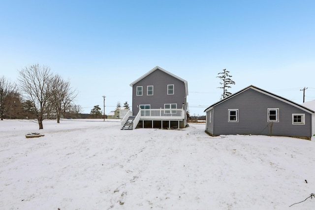 snow covered property featuring a wooden deck