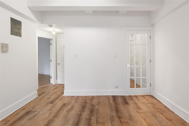 unfurnished room with hardwood / wood-style flooring