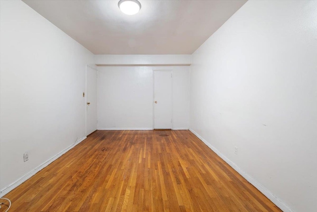 unfurnished room with wood-type flooring